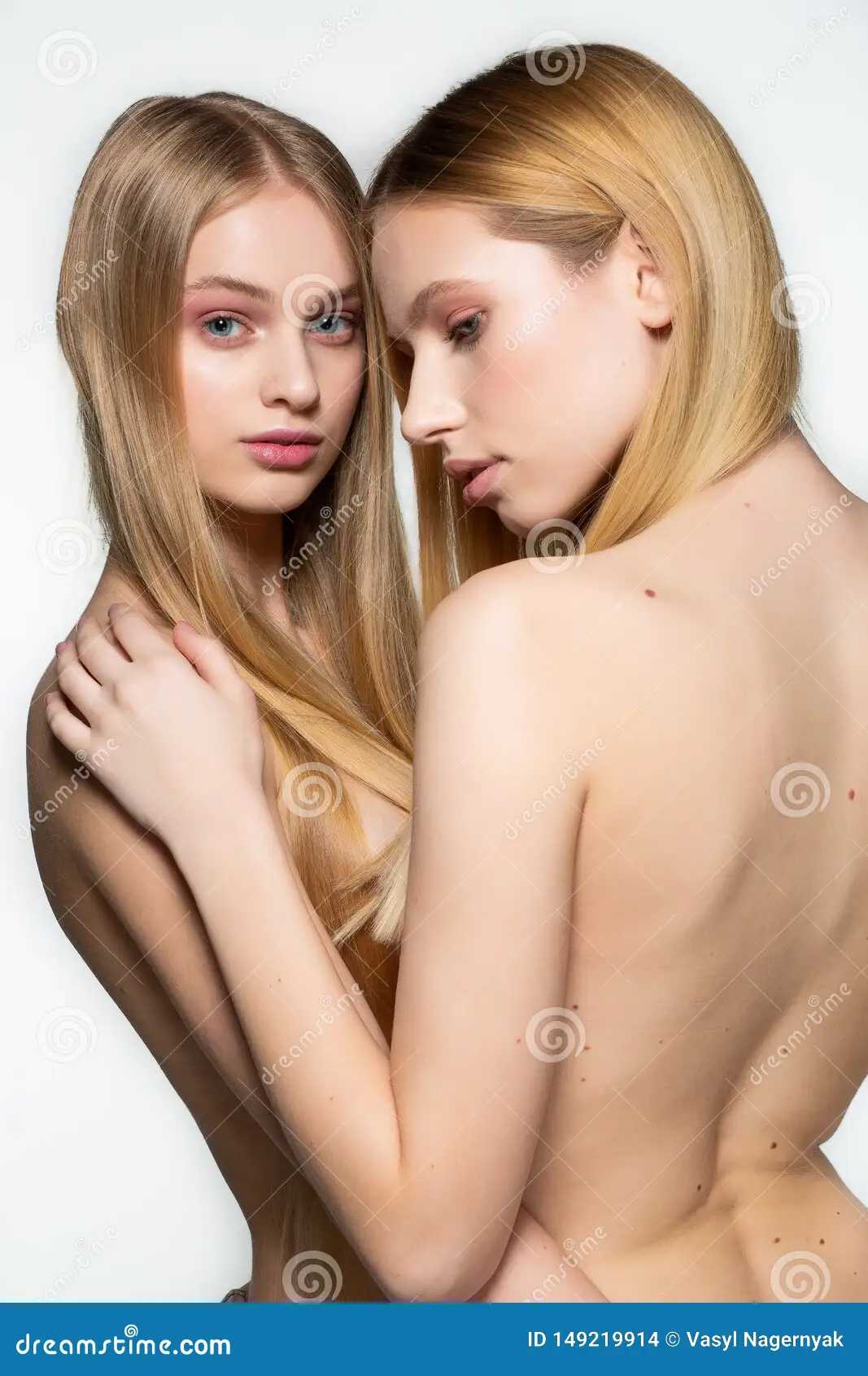 Two Beautiful Young Half Naked Lesbians with Long Blonde Hair Posing in Each Others Arms Isolated Over White Stock Photo