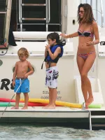 leggy alessandra ambrosio enjoys a drink on the beach with friends
