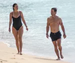 leggy alessandra ambrosio enjoys a drink on the beach with friends