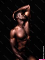 Sensual nude and black man on dark background with muscular body natural or dim light. Confident African American male or strong person shirtless athletic or bodybuilder with wellness or creative Stock Photo