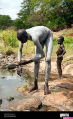 A Suri Surma naked young man body painted with mud Ethiopia Stock Photo