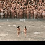 Two women join thousands of other nude volunteers during American photographer Spencer Tunicks installation in Mexico Citys Zocalo on May 6 2007. The controversial artist known for his monumental installations featuring abstract