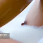Womans breast in bubble bath