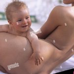 Mother baby in the nude woman lie back view summer child small 5 months infant smile shell contact together happily happily curled inside conception childhood love suture security affection care allowance closeness