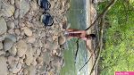 Cute teenage boy naked bath in the river